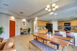 a kitchen and living room with a wooden table and chairs at Pet-Friendly Albuquerque Vacation Escape! in Albuquerque