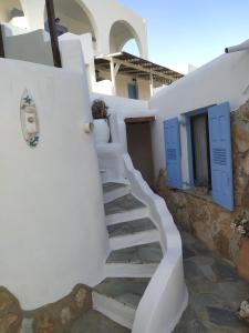 Una escalera blanca con puertas azules en un edificio en Lucas B Panorama en Alopronia
