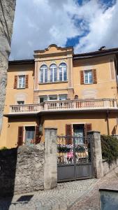 a large house with a fence in front of it at Camere vecchio borgo in Bormio