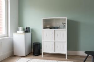 a white cabinet in a room next to a window at Happy Day´s in Amsterdam