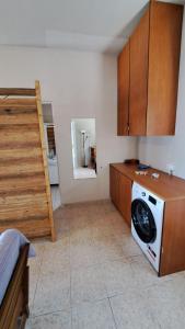 a kitchen with a washing machine and a staircase at Beachfront 2-bedroom apartment in Salamís +15 photos