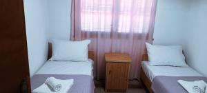 a small room with two beds and a table at Villas Kiriaki in Kallirákhi
