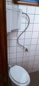 a bathroom with a white toilet with a hose at Villas Kiriaki in Kallirákhi