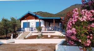 a house with purple flowers in front of it at Villas Kiriaki in Kallirákhi +44 photos