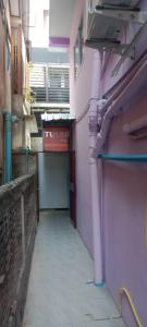 a hallway of a building with pink pipes on the side at Tulsi Inn at Walking Street in Pattaya South