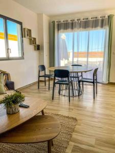 a living room with a table and chairs at Villa cap zen and spa in Petite Île