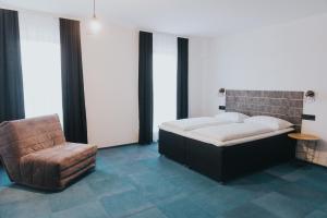 1 cama y 1 silla en una habitación en Arena Bakarni, en Brčko