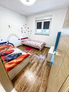 a bedroom with two beds and a window at APARTMENT SECRET GARDEN 3 in Zaton