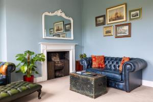 a living room with two couches and a mirror at Crescent Green in Bath