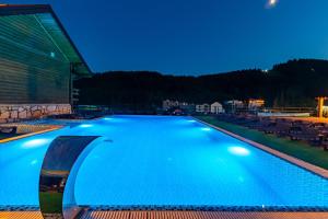 a swimming pool at night with lights on at Gold Palace Bukovel in Bukovel