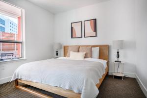 a white bedroom with a large bed and a window at Redwood City 1BR w Lounge Gym WD nr Caltrain SFO-1082 in Redwood City