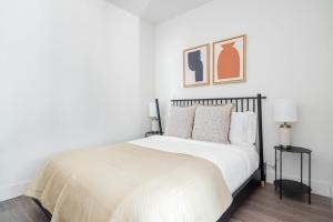 a white bedroom with a bed with a black frame at Mountain View Studio w Gym WD nr 101 SFO-673 in Los Altos +43 photos