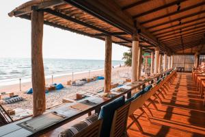 a restaurant on the beach with chairs and tables at Kacha Resort & Spa, Koh Chang in Ko Chang