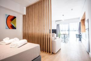 a bedroom with a bed and a living room at LASARI comfort living in Thessaloniki