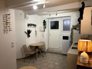 a kitchen with a table and chairs and a door at Hyper centre - proche Castillet in Perpignan