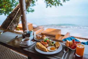 a breakfast table with eggs and bread and toast at Kacha Resort & Spa, Koh Chang in Ko Chang