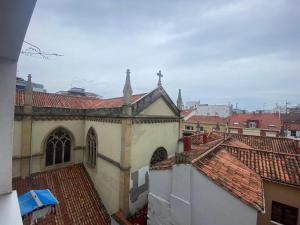 a view of a church with red tile roofs at Apartamento Centro Gijón Los Patos in Gijón