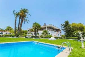 a villa with a swimming pool in front of a house at 250 Finca CODOVI - Alicante Holiday in Los Montesinos