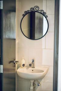 a bathroom with a sink and a mirror on the wall at The Majestic-Loft De Tel in Ipoh