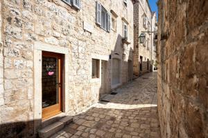 an alley in an old stone building at Studio apartment Fingerprint in Hvar
