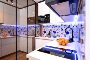 a kitchen with a bowl of oranges on a counter at Studio apartment Fingerprint in Hvar