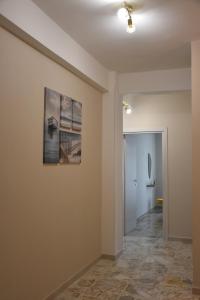 a hallway with a painting on the wall and a hallway with at Russo Apartment in Termoli