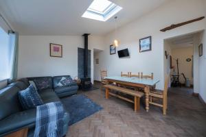 a living room with a couch and a table at Five Acres - Bwnthyn Ar Y Tir in Conwy