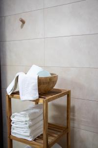 a bathroom with a wooden table with towels on it at Casas rurales La Carrasca in Ossa de Montiel +77 photos