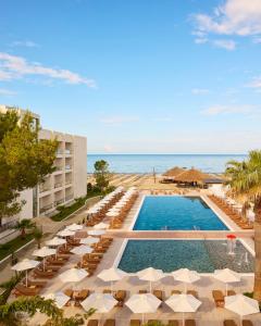 a view of the pool at the resort with chairs and umbrellas at Sol Tropikal Durrës in Durrës