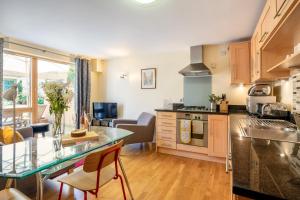 a kitchen and living room with a glass counter top at 10 Summerhouse Mews in York