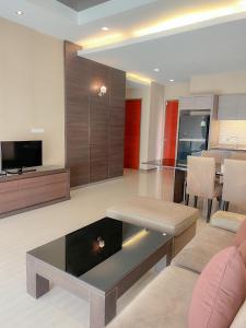 a living room with a couch and a table at Feel Like Home Pool Villa Pattaya in Jomtien Beach