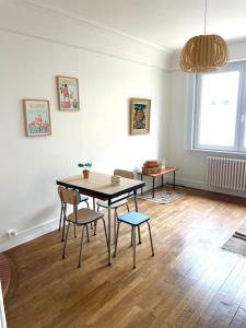 een eetkamer met een tafel en stoelen in een kamer bij La Turenne ! Hypercentre in Lorient