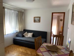 a living room with a couch and a table at Guesthouse Šimag in Rab +10 photos