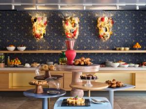 a kitchen with a bunch of food on a wall at Hyatt Centric Murano Venice in Murano