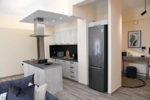 a kitchen with a black refrigerator in a room at Konstantina Apartment in Athens +18 photos