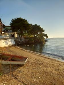 a boat sitting on a beach next to the water at Paparoúna 5 min from beach in Nikiti