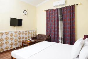 a hotel room with a bed and a chair at ORION INN Guest House F-7 Islamabad in Islamabad