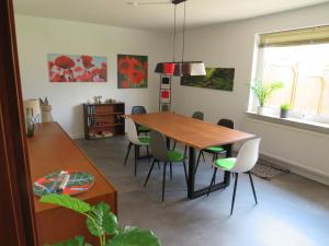 a dining room with a wooden table and chairs at Ferienhaus PH 17 in Krummhörn