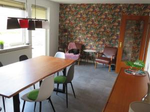 a dining room with a table and chairs at Ferienhaus PH 17 in Krummhörn