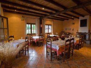 a restaurant with tables and chairs in a room at Villa La Margarita Rocabella in El Chorro