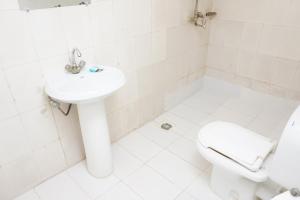 a white bathroom with a sink and a toilet at ORION INN Guest House F-7 Islamabad in Islamabad