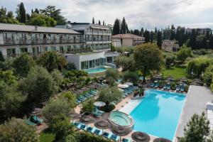 an aerial view of a hotel with a pool and chairs at Olivi Hotel & Natural Spa in Sirmione