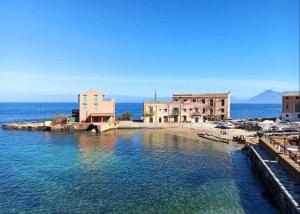 a group of buildings on a body of water at Sea sicily home in Santa Flavia