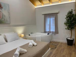 Voodi või voodid majutusasutuse Goninos Jacuzzi Suite toas