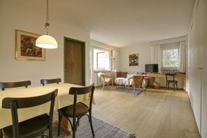 uma sala de jantar e sala de estar com mesa e cadeiras em Residenza Lagrev 2 Zimmerwohnung - Nr 002 - Typ 21A - Hochparterre - Süd West em Sils Maria