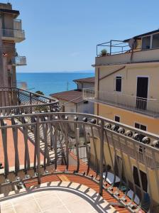 a balcony with a view of a building and the ocean at Casa Vacanza Riviera dei Saraceni in Trebisacce