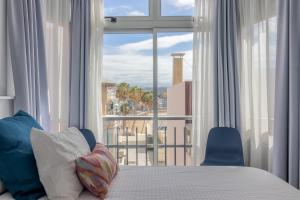 a bedroom with a bed and a large window at Over the Sea Los Lisos in Las Palmas de Gran Canaria