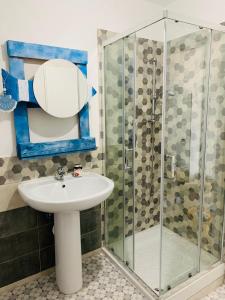 a bathroom with a sink and a shower at B&B Casa Chicchina in Ischitella +28 photos