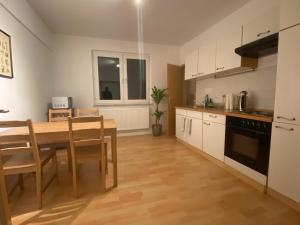 a kitchen with a wooden table and a dining room at Sali - E4 - WLAN, Waschmaschine in Essen