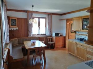 a kitchen with a table and a dining room at Einfamilienhaus am Land Ortsteil Mellach nähe Graz in Mellach